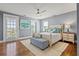 Cozy bedroom with hardwood floors, a comfortable bed, and ample natural light at 511 Windward Psge, Clearwater Beach, FL 33767