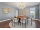 Elegant dining room featuring a round table, unique chandelier, and hardwood floors at 511 Windward Psge, Clearwater Beach, FL 33767