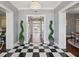 Elegant foyer with black and white checkered floors and views of the water at 511 Windward Psge, Clearwater Beach, FL 33767