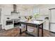 Modern kitchen with white cabinets, marble countertops, and stainless steel appliances at 511 Windward Psge, Clearwater Beach, FL 33767