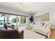 Bright living room with a crystal chandelier and sliding doors to the backyard at 511 Windward Psge, Clearwater Beach, FL 33767