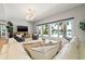 Comfortable living room with backyard views, neutral tones and a plush sofa at 511 Windward Psge, Clearwater Beach, FL 33767