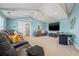 Spacious living room with high ceilings, comfortable seating, and a large screen television at 511 Windward Psge, Clearwater Beach, FL 33767