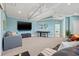 Open living room features a TV, comfortable seating, and access to other areas of the home at 511 Windward Psge, Clearwater Beach, FL 33767