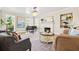 Cozy living room with fireplace, piano and neutral color palette at 511 Windward Psge, Clearwater Beach, FL 33767