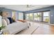 Bright main bedroom with balcony access, wood floors, and comfortable furnishings at 511 Windward Psge, Clearwater Beach, FL 33767