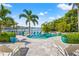 Inviting backyard with a sparkling pool, spa, lounge chairs and direct access to the channel at 511 Windward Psge, Clearwater Beach, FL 33767