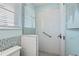 Bright and clean tiled shower with glass door and handicap bar at 511 Windward Psge, Clearwater Beach, FL 33767