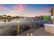Waterfront view from the dock featuring a serene waterway with picturesque homes and evening sky at 511 Windward Psge, Clearwater Beach, FL 33767