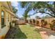 Spacious backyard with a shed, new wooden fence, and green lawn with mature trees at 516 Northmoor N Ave, St Petersburg, FL 33702