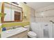 Accessible bathroom featuring a walk-in tub, vanity with sink, and neutral tiling for a comfortable experience at 516 Northmoor N Ave, St Petersburg, FL 33702