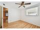 Bright bedroom featuring hardwood flooring, a door to the hallway, and one window at 516 Northmoor N Ave, St Petersburg, FL 33702