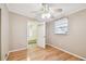 Bright bedroom featuring hardwood flooring, a door to the stairs, and one window at 516 Northmoor N Ave, St Petersburg, FL 33702
