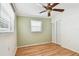 Bright bedroom with hardwood flooring, fan, closet, and green accent wall at 516 Northmoor N Ave, St Petersburg, FL 33702