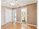 Bedroom featuring a closet, doorway to another room, and an ensuite bathroom, all with hardwood floors at 516 Northmoor N Ave, St Petersburg, FL 33702