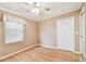 Bedroom featuring hardwood floors, a window with blinds, and a spacious closet for storage at 516 Northmoor N Ave, St Petersburg, FL 33702