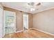 Bedroom with a ceiling fan and a doorway offering a peek into the bright, white kitchen space at 516 Northmoor N Ave, St Petersburg, FL 33702
