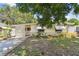 Quaint one-story home featuring awning-shaded windows and a pleasant, established front garden at 516 Northmoor N Ave, St Petersburg, FL 33702