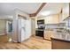 Efficient kitchen layout with ample counter space, stainless steel appliances, and modern wood-look flooring at 516 Northmoor N Ave, St Petersburg, FL 33702