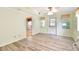 Spacious living room with a door to the outside, laminated floors, and neutral paint throughout at 516 Northmoor N Ave, St Petersburg, FL 33702