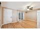 Inviting living room featuring hardwood floors, a ceiling fan, and sliding glass doors for natural light at 516 Northmoor N Ave, St Petersburg, FL 33702
