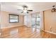 Comfortable living room featuring hardwood floors, ceiling fan, and sliding glass doors for seamless outdoor access at 516 Northmoor N Ave, St Petersburg, FL 33702