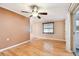 Cozy living area with polished hardwood floors, a ceiling fan, and a large window for plenty of light at 516 Northmoor N Ave, St Petersburg, FL 33702