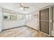 Bright room with grey linoleum flooring, 3 windows, and a back door at 516 Northmoor N Ave, St Petersburg, FL 33702