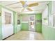Enclosed sunroom featuring tile flooring, multiple windows and a ceiling fan for added comfort at 516 Northmoor N Ave, St Petersburg, FL 33702