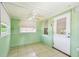 Charming sunroom featuring tile flooring, three windows and a ceiling fan for added comfort at 516 Northmoor N Ave, St Petersburg, FL 33702