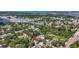 Aerial view features homes nestled amidst lush trees, with a waterway providing a tranquil backdrop at 5323 73Rd N St, St Petersburg, FL 33709