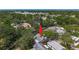 Aerial view showcases home nestled among mature trees in a serene neighborhood setting at 5323 73Rd N St, St Petersburg, FL 33709
