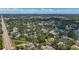 Expansive aerial view showcases city buildings in distance and surrounding homes amidst lush trees at 5323 73Rd N St, St Petersburg, FL 33709