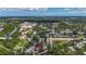 Aerial view of neighborhood showcasing many homes and mature trees near a waterway and roadway at 5323 73Rd N St, St Petersburg, FL 33709