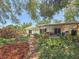Landscaped backyard featuring lush tropical foliage, a covered patio, and a private outdoor living space at 5323 73Rd N St, St Petersburg, FL 33709