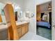 Bright bathroom with a mirror, vanity, and doorway to bedroom at 5323 73Rd N St, St Petersburg, FL 33709