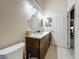 Modern bathroom with double sinks, marble countertops, and a door to another room at 5323 73Rd N St, St Petersburg, FL 33709