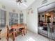 A bright dining area features tile floors, a ceiling fan and natural light from multiple windows at 5323 73Rd N St, St Petersburg, FL 33709