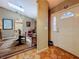 Inviting foyer with a decorative front door and view into the dining room at 5323 73Rd N St, St Petersburg, FL 33709