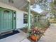 Charming doorway featuring a green door with sidelights and neatly manicured landscaping at 5323 73Rd N St, St Petersburg, FL 33709