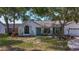 Inviting home featuring a quaint front yard with lush greenery and a charming front entrance at 5323 73Rd N St, St Petersburg, FL 33709