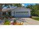 Attached garage offering ample space for parking and storage, set against a sunny backdrop at 5323 73Rd N St, St Petersburg, FL 33709