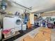 Functional garage with washer, dryer, utility sink, and storage cabinets at 5323 73Rd N St, St Petersburg, FL 33709