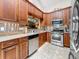 The kitchen features stainless steel appliances, stone countertops and a pass-through view to another room at 5323 73Rd N St, St Petersburg, FL 33709