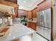 Well-equipped kitchen featuring stainless steel appliances, granite counters, and wood cabinetry at 5323 73Rd N St, St Petersburg, FL 33709