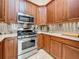 This kitchen features stainless steel appliances, stone countertops, recessed lighting and wooden cabinets at 5323 73Rd N St, St Petersburg, FL 33709