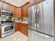 The kitchen features stainless steel appliances, stone countertops, recessed lighting and wood cabinets at 5323 73Rd N St, St Petersburg, FL 33709