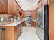 A well-lit kitchen features stainless steel appliances, stone countertops and decorative backsplash at 5323 73Rd N St, St Petersburg, FL 33709