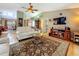 Inviting living room with hardwood floors, a ceiling fan, and a view into multiple living areas at 5323 73Rd N St, St Petersburg, FL 33709