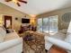 Cozy living room with plush seating, a ceiling fan, and sliding glass doors to the outdoor pool area at 5323 73Rd N St, St Petersburg, FL 33709
